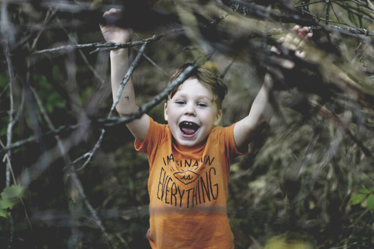 Child playing with t shirt saying "imagination is everything"